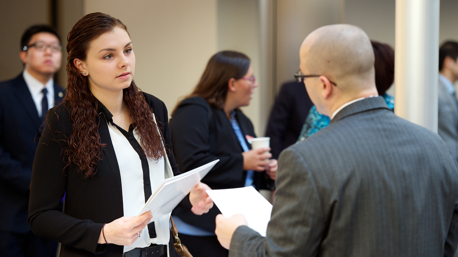 A student speaking with a professional at a networking event