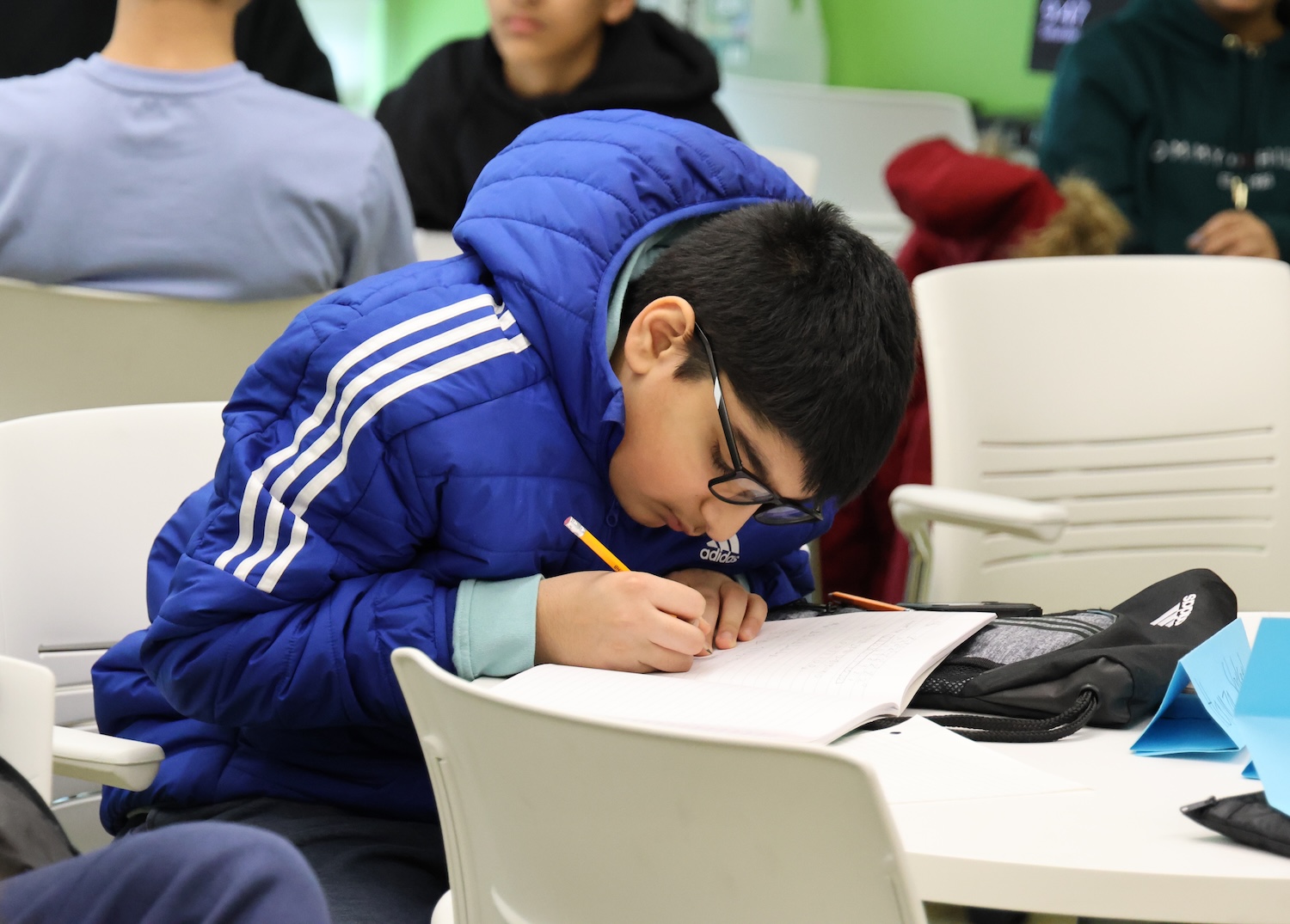 An ICPS participant taking diligent notes during class