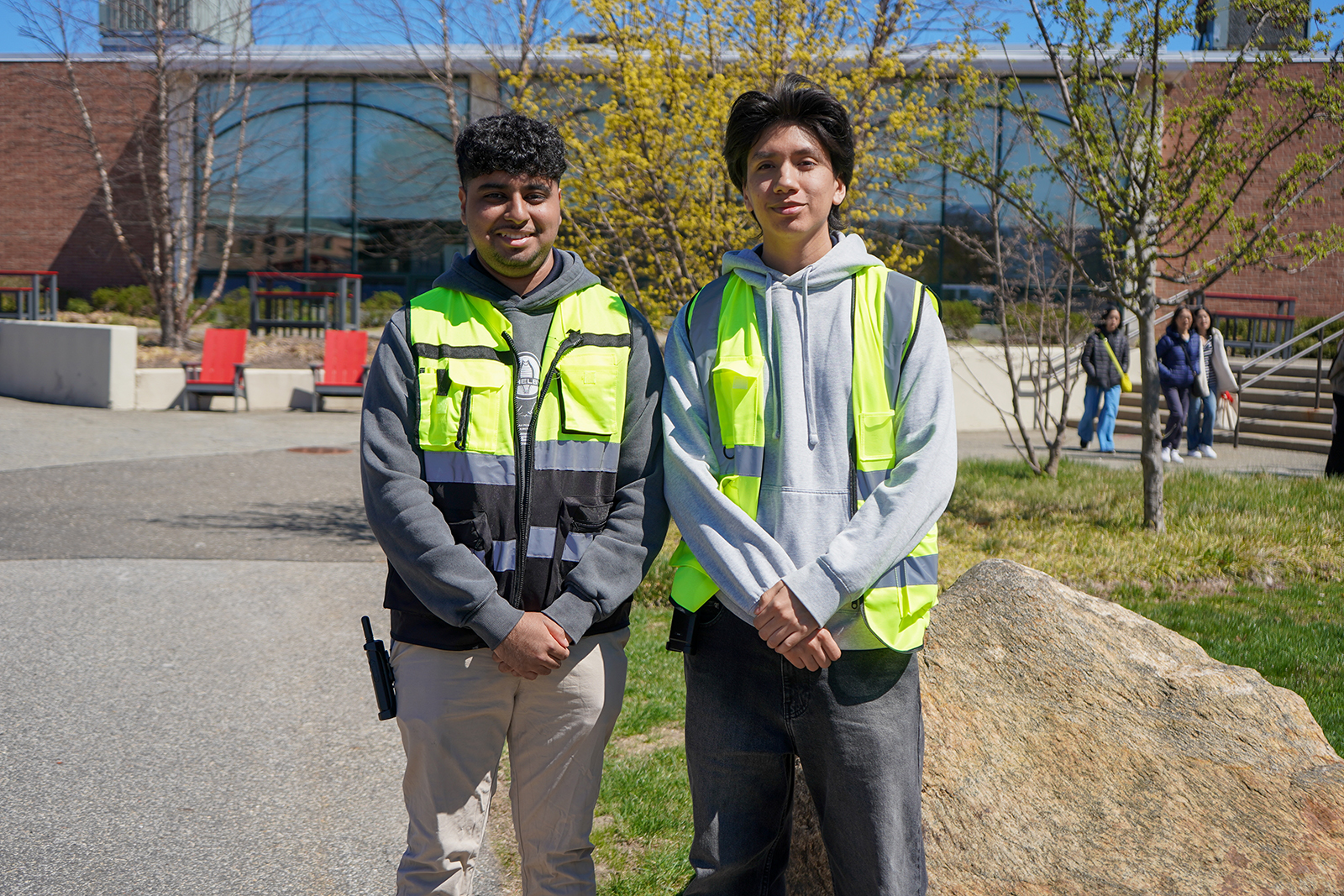 Two students working for RSP wearing neon vests working.